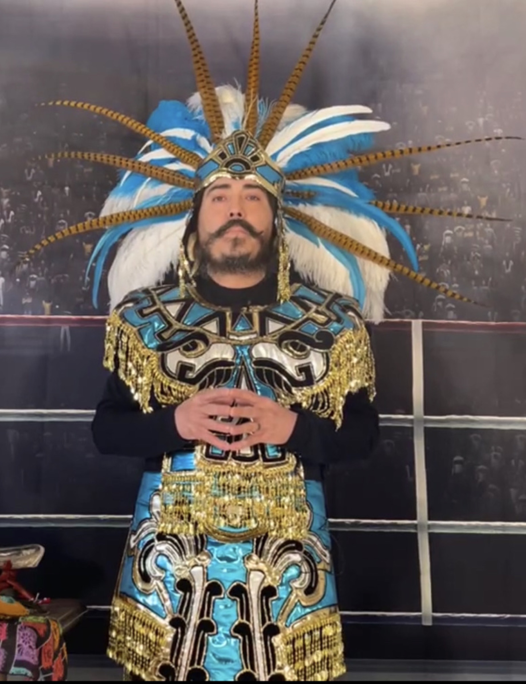 Ceremonial Aztec warrior regalia — feathers and obsidian under low light.